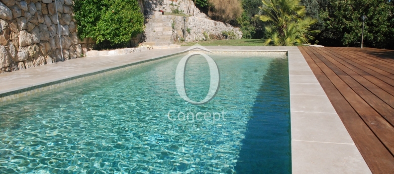 Beige mosaic tiles making a green pool by Ô Concept